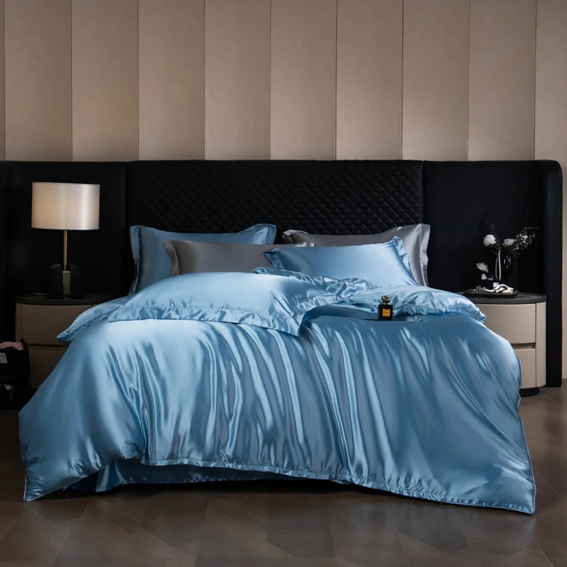 Blue satin bedding set on a bed with a striped wall background