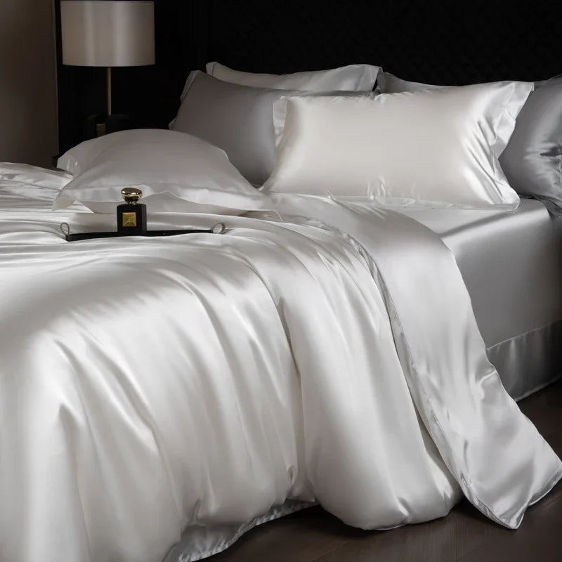 Silky white bedding set on a bed with a dark background