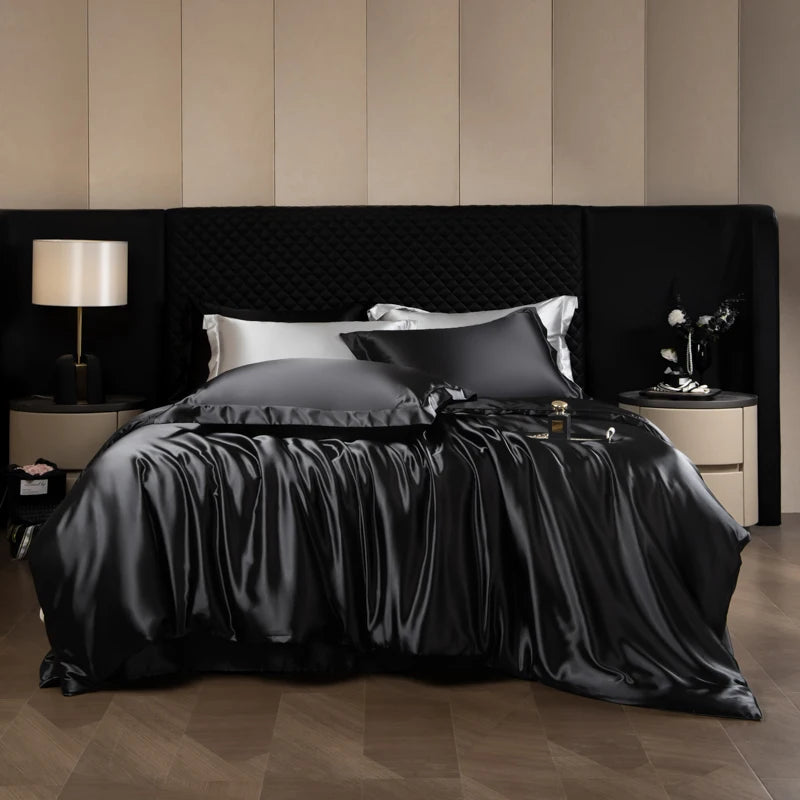 Black satin bedding set on a bed with matching headboard and nightstands.