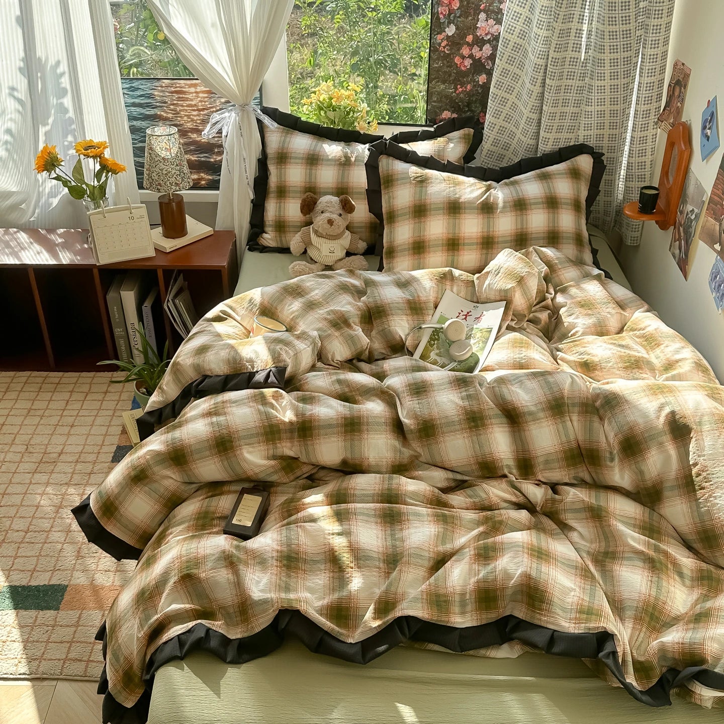 Plaid bedspread on a bed in a room with a window and decor.