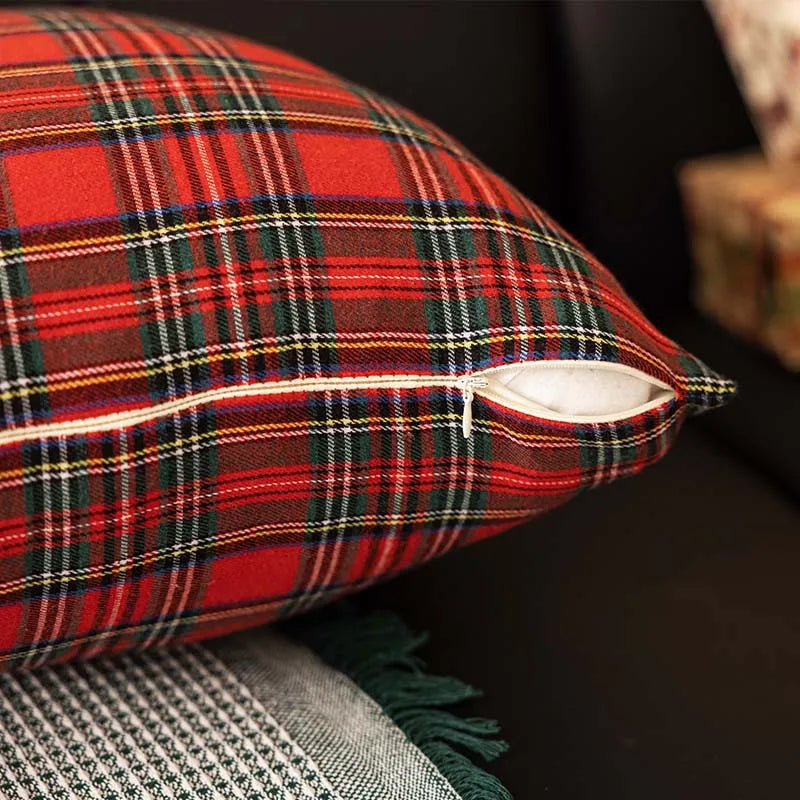 Red plaid pillow on a dark surface