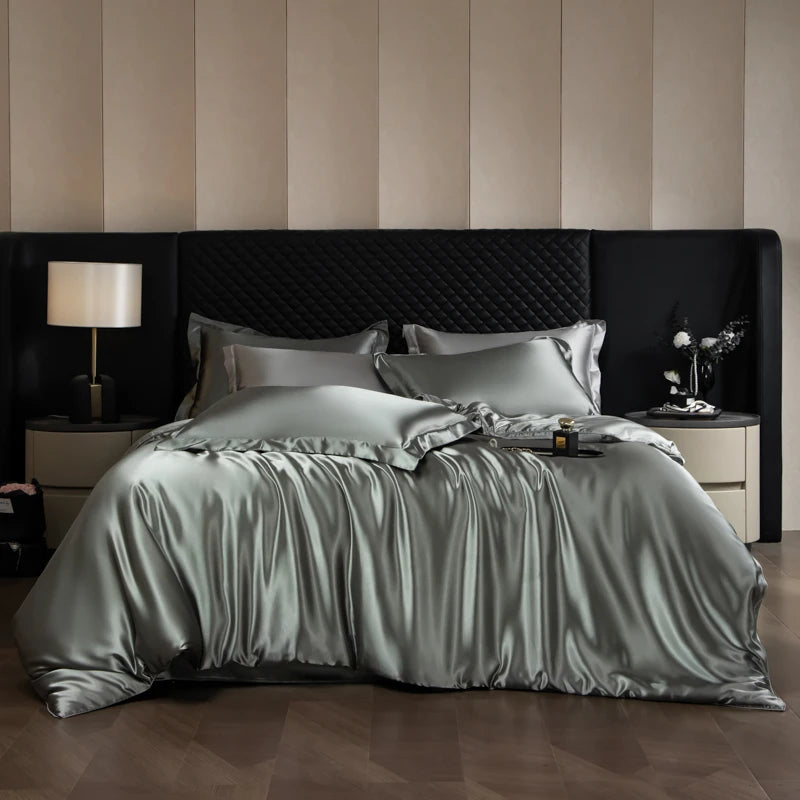 Bed with satin bedding in a bedroom setting with striped wallpaper.